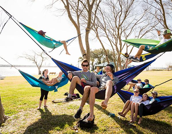 A group of students lounging in hammocks by the St. Johns River.